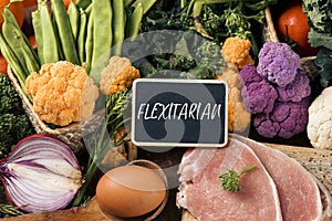 Raw vegetables, eggs and meat and text flexitarian