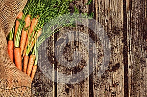 Raw vegetables food, carrot top view on old wooden background