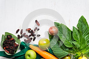 Raw vegetables and fruits with textile bag, top view