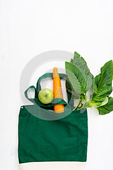 Raw vegetables and fruits with textile bag, top view