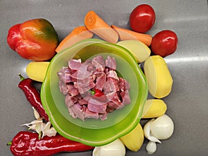 raw vegetables with meat for cooking on a cutting board