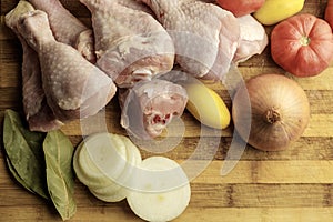 Raw vegetables and poultry ingredients for meals in the evening, cook chopped and will soon be cooking, wooden background