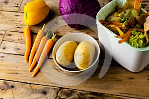Raw vegetables and vegetable waste in kitchen composting bin