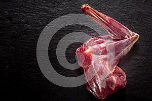 Raw Venison Deer Haunch on Dark Textured Surface