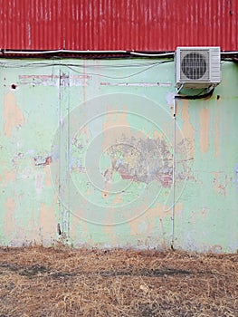 raw vintage wall with airconditioner from old shop lot with aged paint