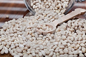 Raw white beans in glass bowl