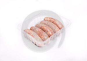 Raw white sausages in a plastic container, isolated. Polish Easter delicacy. A packshot photo, for package design.