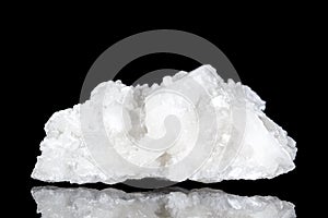 Raw white stilbite or desmine mineral stone in front of black background