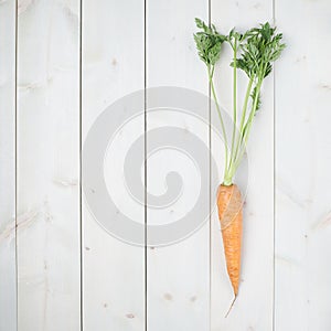Raw whole carrot on wooden surface table