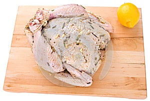 Raw whole chicken on a cutting board