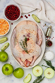 Raw whole duck for baking with apples, cranberries, sauerkraut and spices