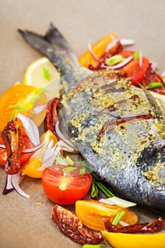 Raw whole sea bream fish and vegetables ingredients