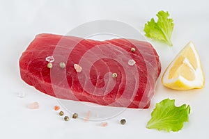 Raw yellow fin tuna Thunnus albacares fish steak on white background