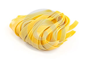 Raw yellow italian pasta pappardelle, fettuccine or tagliatelle