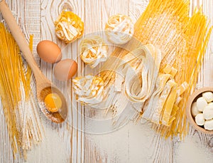 Raw yellow italian pasta pappardelle, fettuccine or tagliatelle