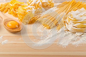 Raw yellow italian pasta pappardelle, fettuccine or tagliatelle