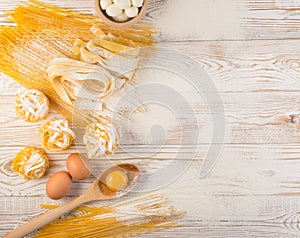 Raw yellow italian pasta pappardelle, fettuccine or tagliatelle