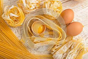 Raw yellow italian pasta pappardelle, fettuccine or tagliatelle