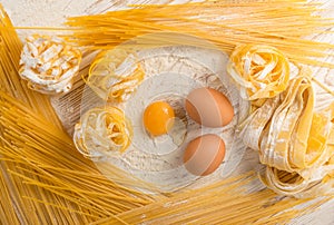 Raw yellow italian pasta pappardelle, fettuccine or tagliatelle