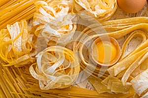 Raw yellow italian pasta pappardelle, fettuccine or tagliatelle