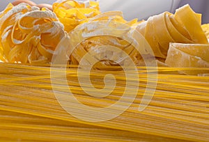 Raw yellow italian pasta pappardelle, fettuccine or tagliatelle texture