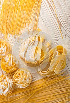 Raw yellow italian pasta pappardelle, fettuccine or tagliatelle texture