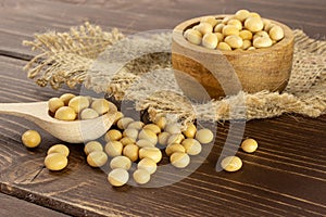 Raw yellow soya bean on brown wood