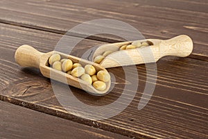 Raw yellow soya bean on brown wood