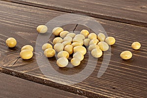 Raw yellow soya bean on brown wood