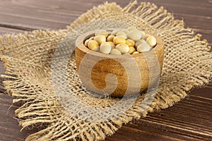 Raw yellow soya bean on brown wood