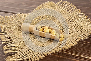 Raw yellow soya bean on brown wood