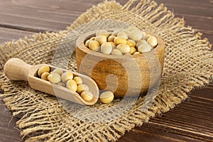 Raw yellow soya bean on brown wood