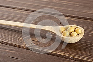 Raw yellow soya bean on brown wood