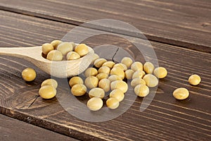 Raw yellow soya bean on brown wood