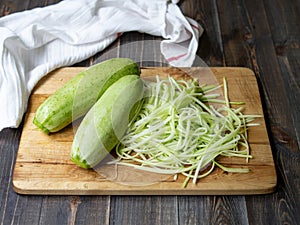 Raw zucchini noodles on the wooden table, close uo, top view. vegan. Healthy food