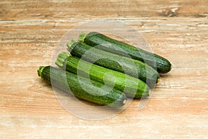 Raw zucchini on wooden table