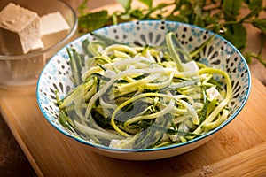 raw zucchinis salad with feta cheese