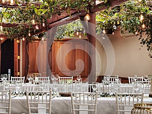 Raws of white chairs and tables at a celebration hall