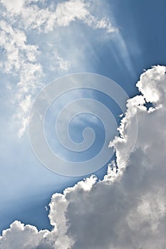 Rays through the clouds on blue sky