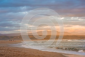 Rays of golden evening light falling on the Plettenberg Bay beach at sunset. Garden Route, Western