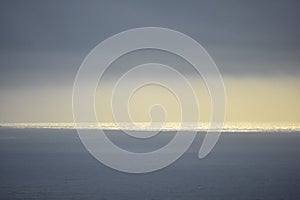 Rays of light that pass over the clouds and illuminate the sea like spotlights. Concept of nature and sea. Galicia, Spain