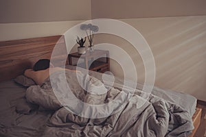 Rays of morning sun shining on young sleeping woman