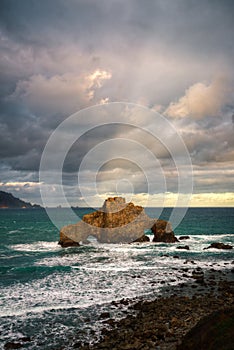 The rays of the rising sun briefly illuminate the clouds in Cabo Ortegal Unesco Geopark