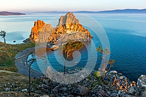 The rays of the rising sun illuminate the rock Shamanka