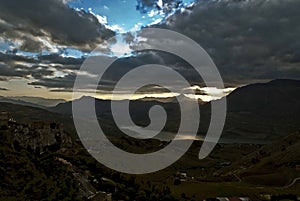 Rays of the setting sun through the dense cloud