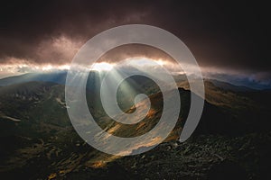 Rays of the setting sun illuminate the mountainous landscape of Tatra mountains, Poland.