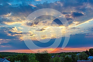 The rays of the sun break through the clouds on a spring evening. Landscape mountains in Slovakia.