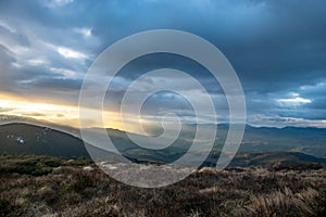 Rays of the sun at sunset in the mountains
