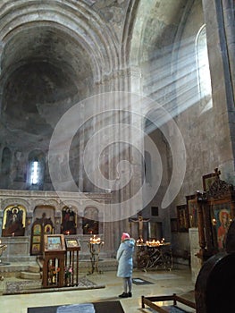 Rays of sunlight penetrating the interior of an ancient Georgian Orthodox church.