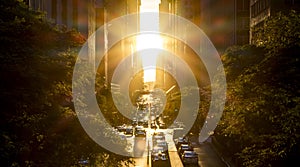 Rays of sunlight shine on the cars and buildings in Midtown New York City